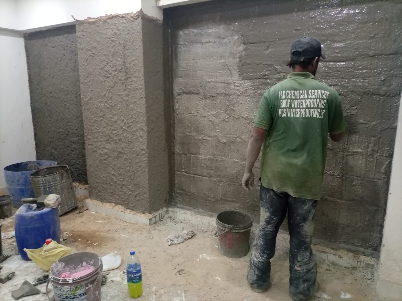 Pak Chemical Services worker applying basement waterproofing treatment