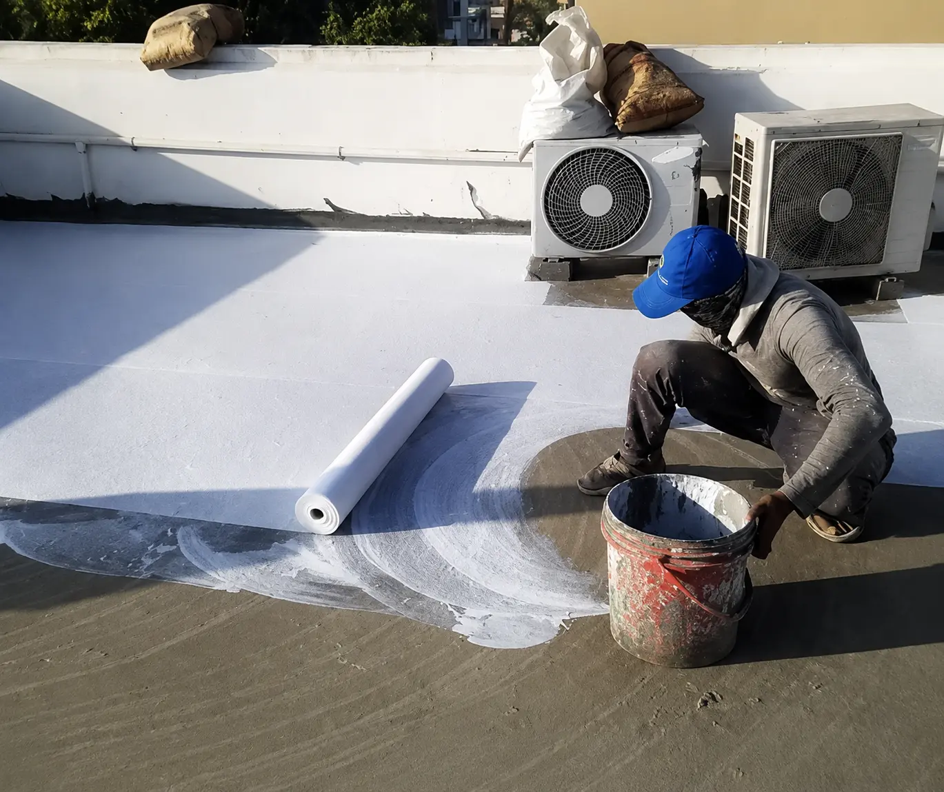 Roof waterproofing membrane application on a commercial rooftop in Karachi